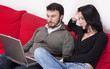 Portrait of a Relaxed Adult Couple Using Laptop at Home