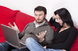 Portrait of a Relaxed Adult Couple Using Laptop at Home