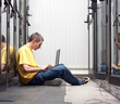 The engineer sits front equipment in datacenter