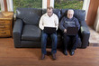 Senior man and his son using laptop computer Senior man and his son using laptop computer