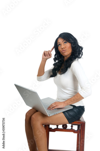 Photo: Woman with laptop pointing finger on head Woman with laptop pointing finger on head