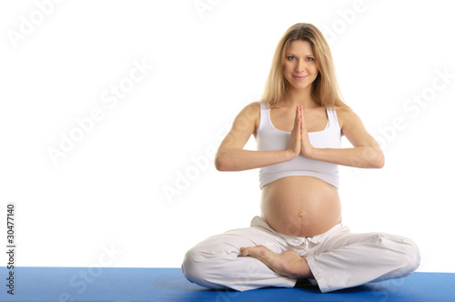Photo: Pregnant woman practicing yoga, sitting Pregnant woman practicing yoga, sitting