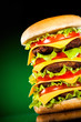 Tasty and appetizing hamburger on a darkly green Tasty and appetizing hamburger on a darkly green