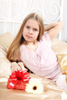 beautiful ten years' girl has seen in bed a gift on birthday.