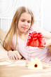 beautiful ten years' girl has seen in bed a gift on birthday.