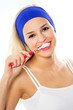 Young happy woman brushing teeth