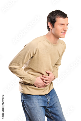 Photo: Young man suffering from a bad stomach ache Young man suffering from a bad stomach ache