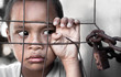 boy behind fence in Asia depicting poverty - focus on hand boy behind fence in Asia depicting poverty - focus on hand