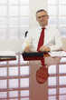 mature businessman smiling at camera