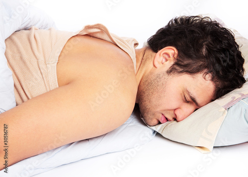 Photo: Young man sleeping in bed Young man sleeping in bed