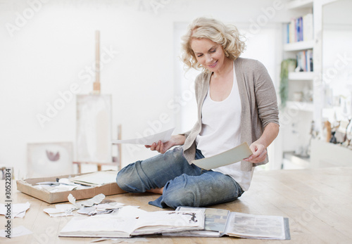 Photo: Smiling woman with photograph album and scrapbook Smiling woman with photograph album and scrapbook