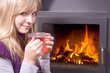 girl drinking tea near the fireplace....