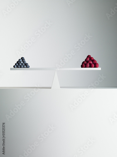 Photo: Blueberries and strawberries balanced on opposite ends of seesaw Blueberries and strawberries balanced on opposite ends of seesaw