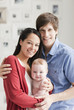 Smiling parents holding baby