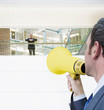Businessman with bullhorn yelling up at boss