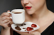 woman holding a cup of black coffee