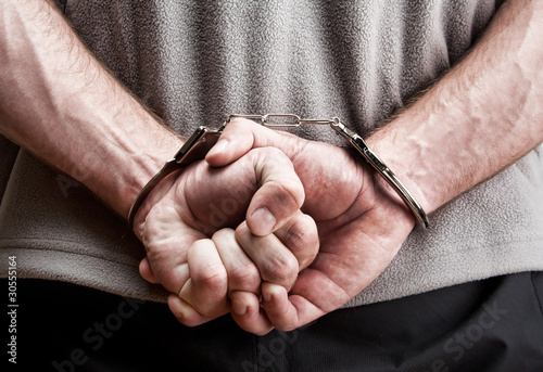 Photo: Criminal in handcuffs Criminal in handcuffs