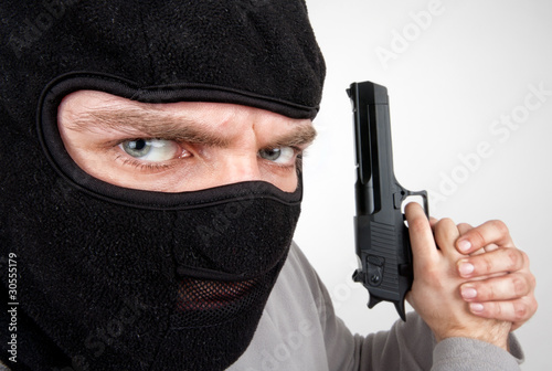 Photo: Serious armed criminal with gun Serious armed criminal with gun
