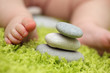 Baby feet next to stack of zen stones, closeup. Baby feet next to stack of zen stones, closeup.