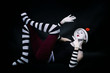 funny mime in white hat  lying on floor