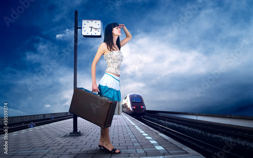 Photo: Girl waiting train on the platform of railway station Girl waiting train on the platform of railway station