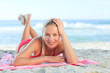 Beautiful woman lying down on the beach Beautiful woman lying down on the beach