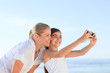 Little girl taking a photo of herself and her mother Little girl taking a photo of herself and her mother