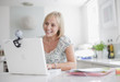 Smiling woman enjoying video chat on laptop