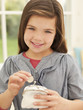 Photo : Smiling girl putting money into coin purse Smiling girl putting money into coin purse