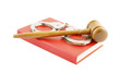 Judge's gavel and handcuffs on red legal book isolated