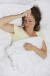 Sick woman laying in bed