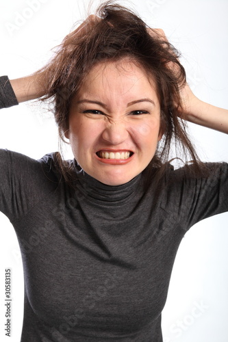 Photo: Frustration pretty young woman tearing out hair Frustration pretty young woman tearing out hair