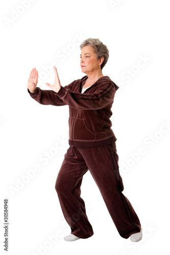 Photo: Senior woman doing Tai Chi Yoga exercise Senior woman doing Tai Chi Yoga exercise