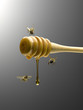 Bees flying around honey dipper dripping with honey