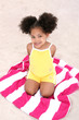 Beautiful Young Girl Sitting On Beach Towel In The Sand