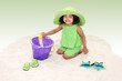 Beautiful Young Girl Sitting In the Sand Playing