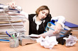 Young businesswoman with tons of documents