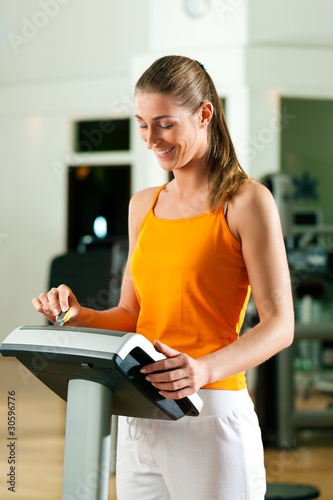 Photo: Woman exercising with modern key system Woman exercising with modern key system