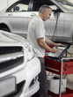 Mechanic using computer in auto repair shop