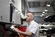 Mechanic using computer in auto repair shop