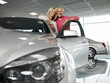 Couple looking at new car in showroom