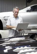Mechanic using computer auto repair shop
