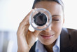 Businesswoman using magnifying glass