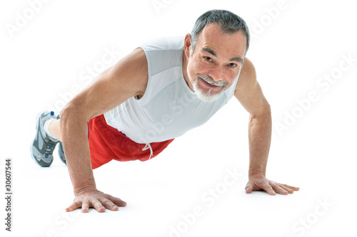 Photo: senior man doing push-ups exercise in gym senior man doing push-ups exercise in gym