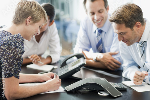Photo: Business people in meeting on conference call Business people in meeting on conference call
