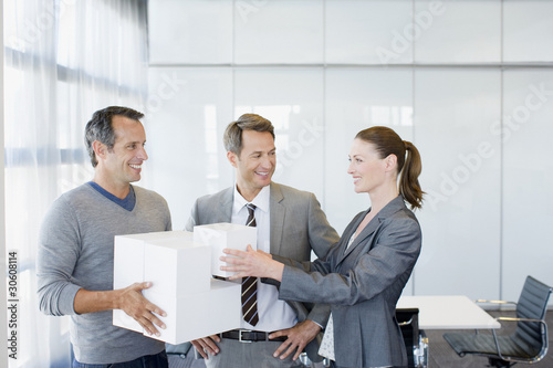 Photo: Business people stacking cubes in conference room Business people stacking cubes in conference room