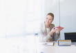 Businesswoman holding circuit board in office