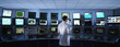 Scientist monitoring computers in control room