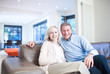 Smiling couple sitting on couch