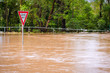 Very flooded road and give way sign, Queensland, Australia